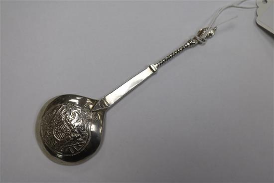 An Indian white metal pouring vessel and a continental apostle spoon.